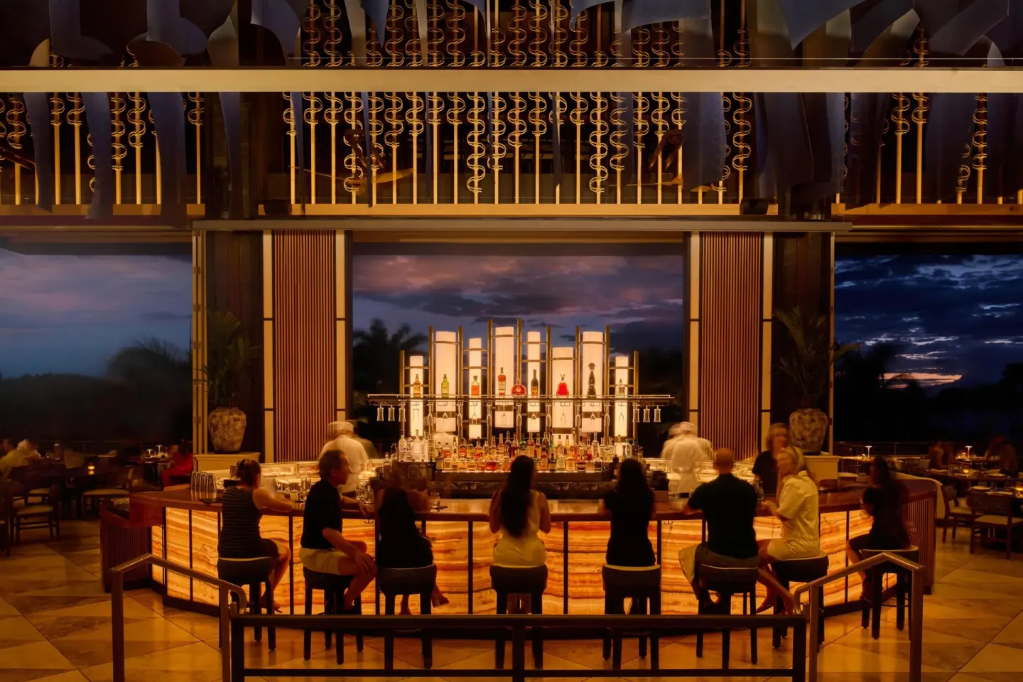 Open-air lobby lounge bar with guests seated at Grand Wailea Maui.