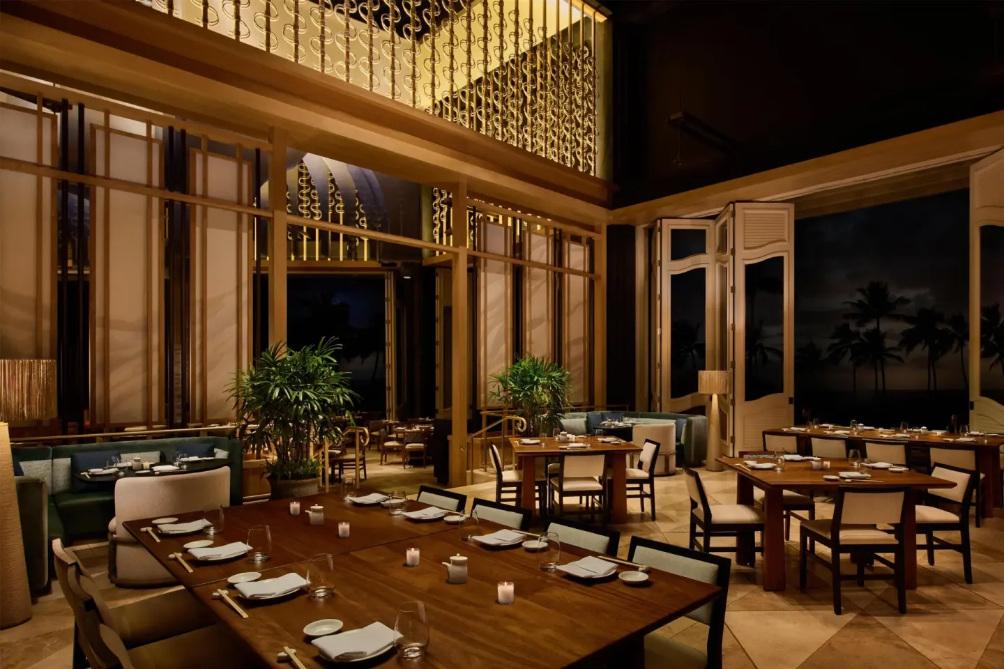 Elegant dining room with wood tables and ocean-facing doors at Grand Wailea Maui.