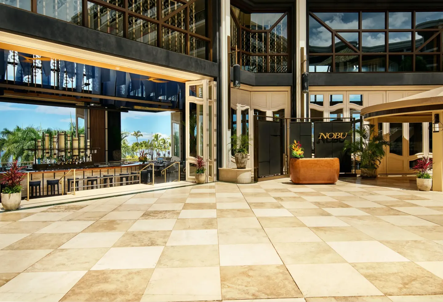Nobu entrance and open dining area with ocean beyond at Grand Wailea Maui.