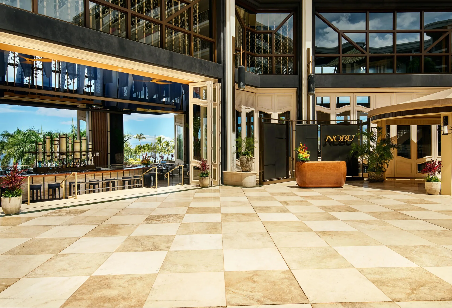 Nobu entrance and open dining area with ocean beyond at Grand Wailea Maui.