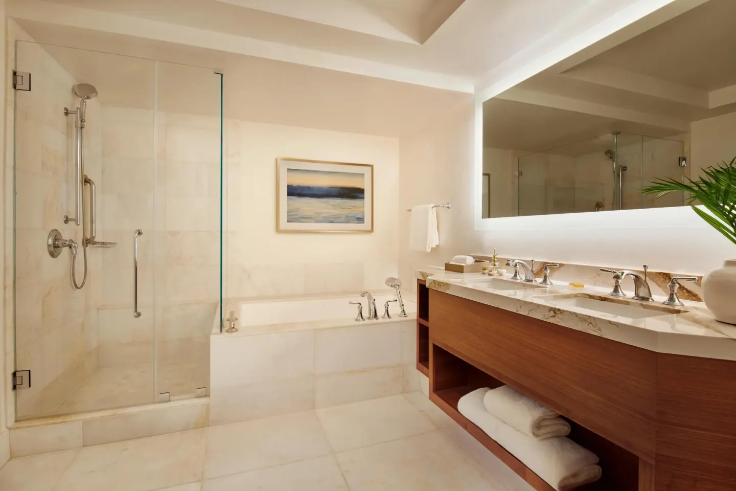 Club Room bathroom with glass shower, soaking tub, and double vanity at Grand Wailea Maui.