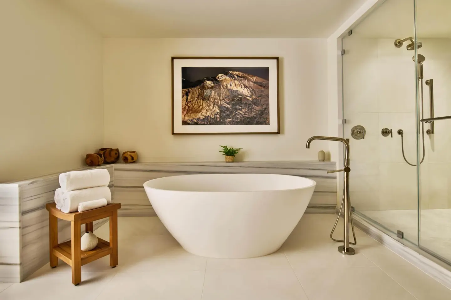 Napua Puakea Suite bathroom with soaking tub and glass shower at Grand Wailea Maui.