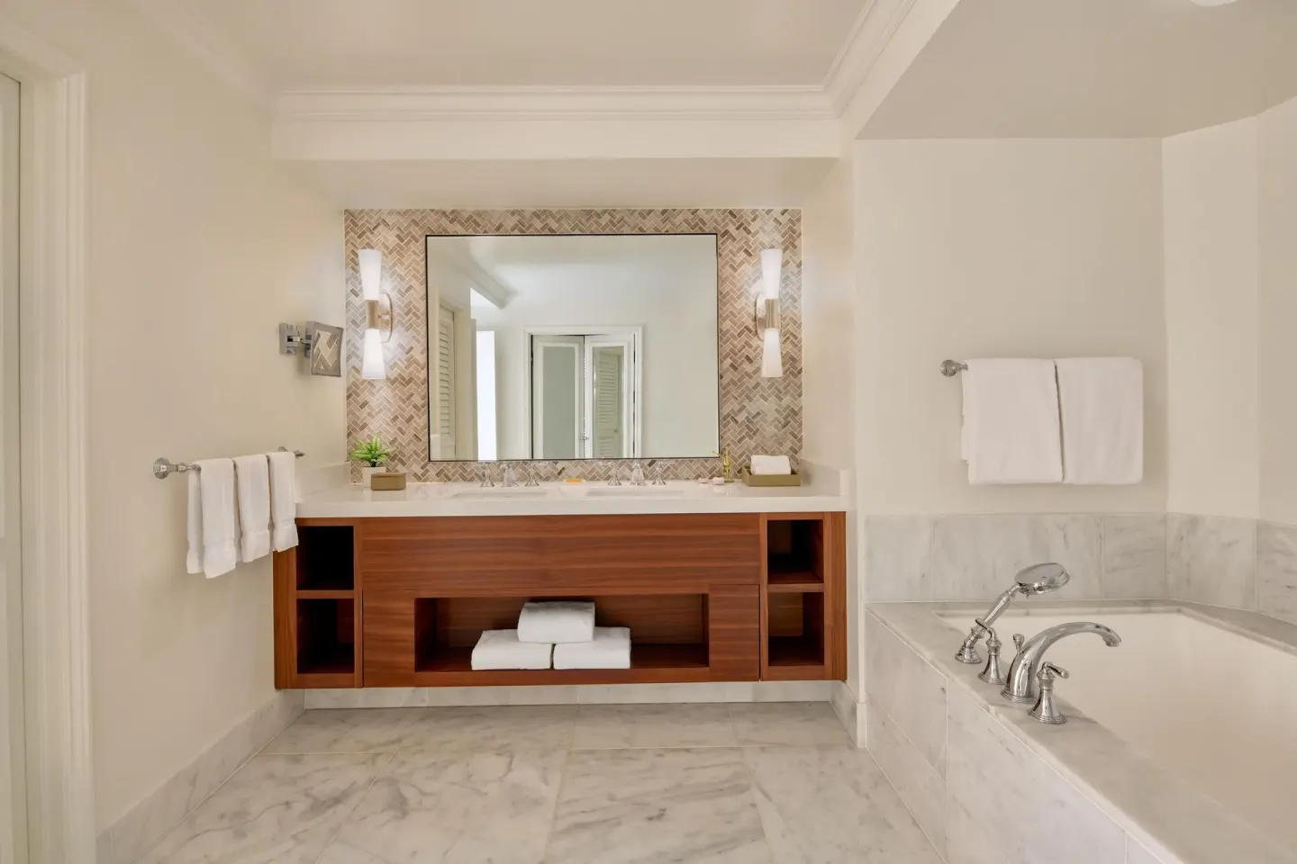Bathroom in the Napua Nani ocean view suite at Grand Wailea Maui with vanity and soaking tub.