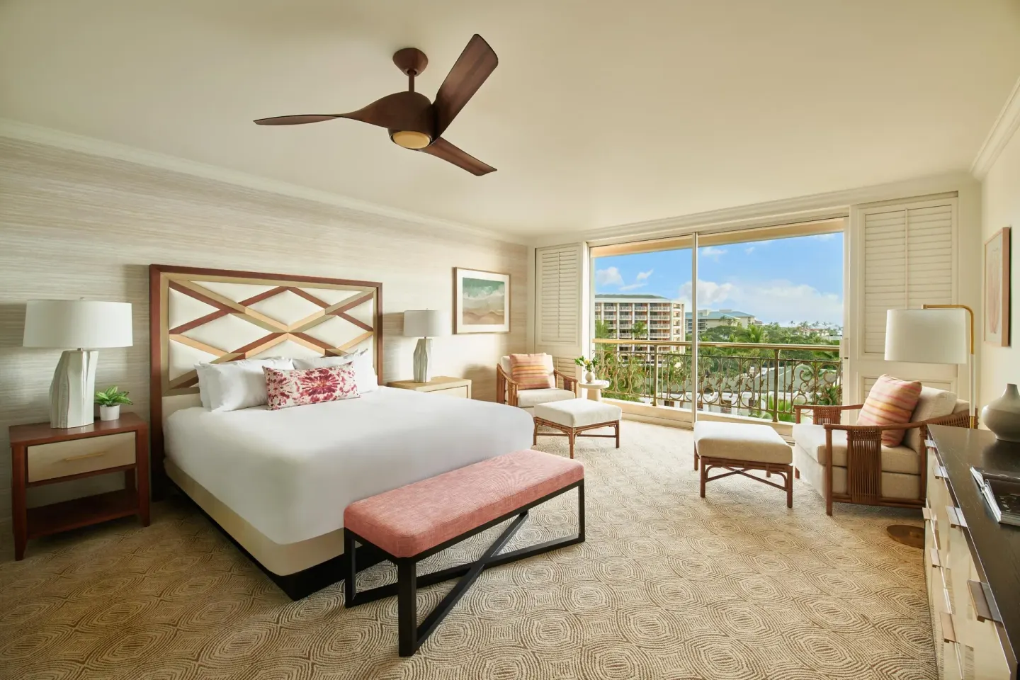 King bedroom in the Napua Nani ocean view suite at Grand Wailea Maui with balcony seating.