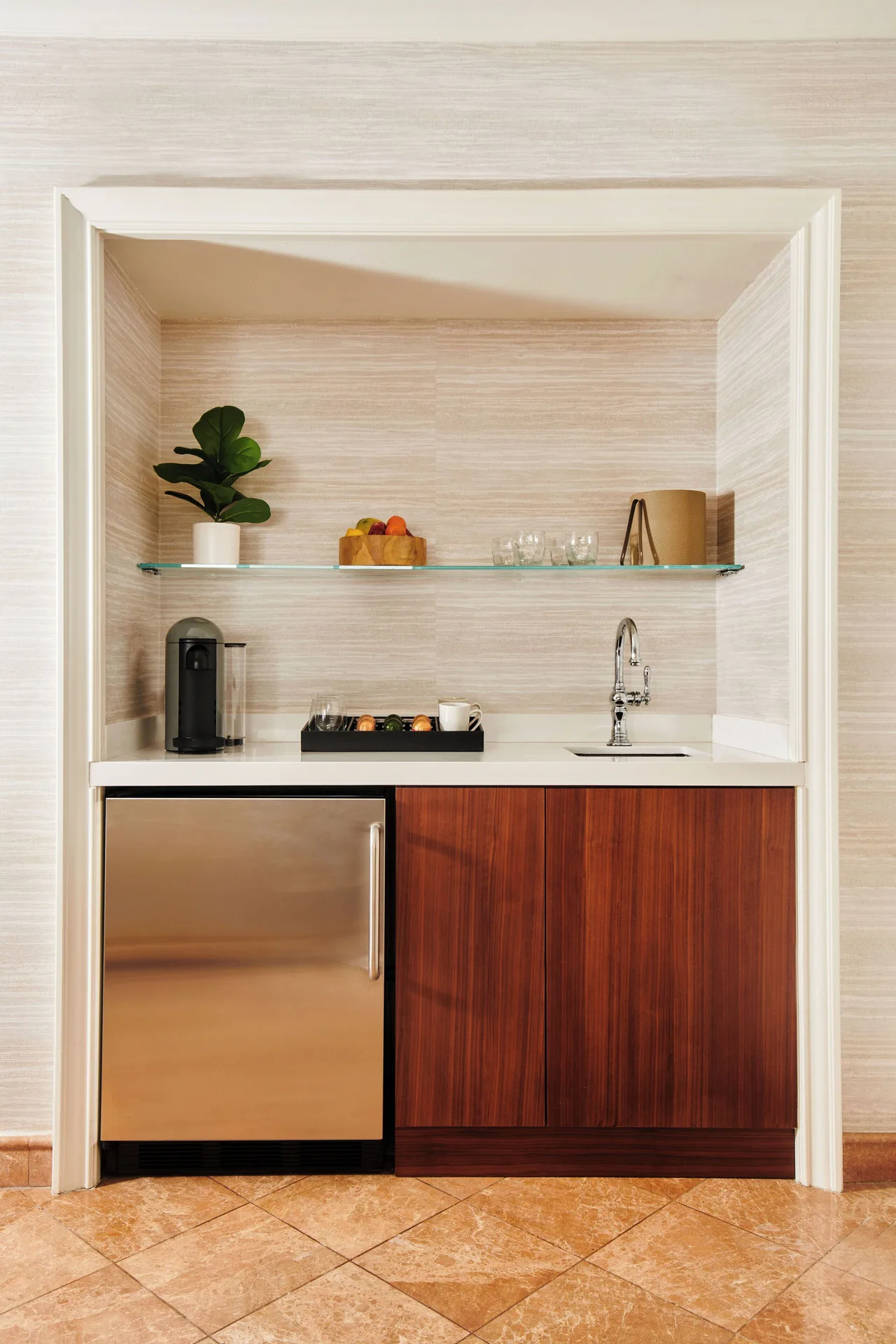 Wet bar in the Napua Nani ocean view suite at Grand Wailea Maui with mini fridge and sink.