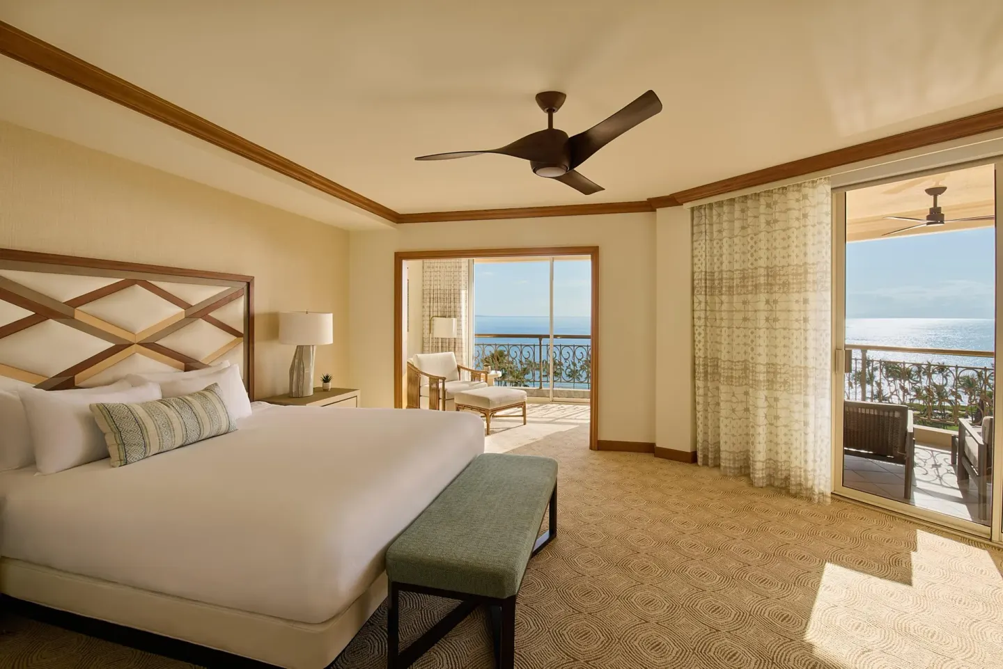 Napua Malu Suite bedroom with king bed and ocean-view balconies at Grand Wailea Maui.