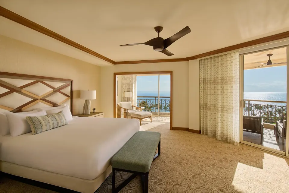 Napua Malu Suite bedroom with king bed and ocean-view balconies at Grand Wailea Maui.