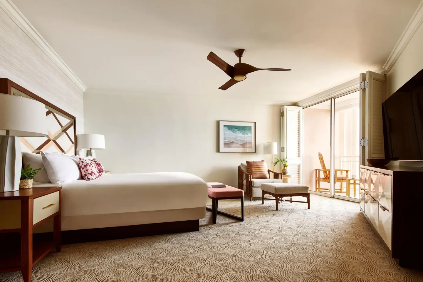 Club Suite bedroom with king bed, seating area, TV, and balcony at Grand Wailea Maui.