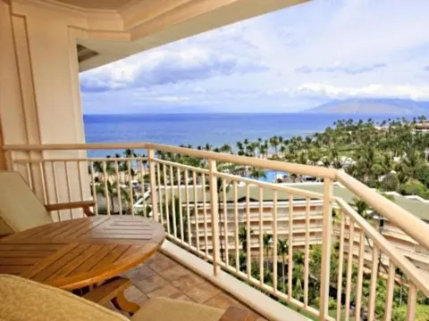 Deluxe Room Ocean View balcony overlooking ocean and palms at Grand Wailea Maui.