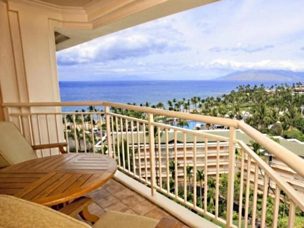 Deluxe Room Ocean View balcony overlooking ocean and palms at Grand Wailea Maui.