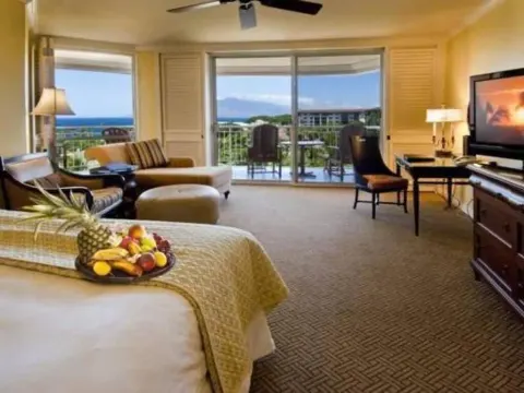 Deluxe Room Ocean View with bed, seating area, balcony and ocean at Grand Wailea Maui.