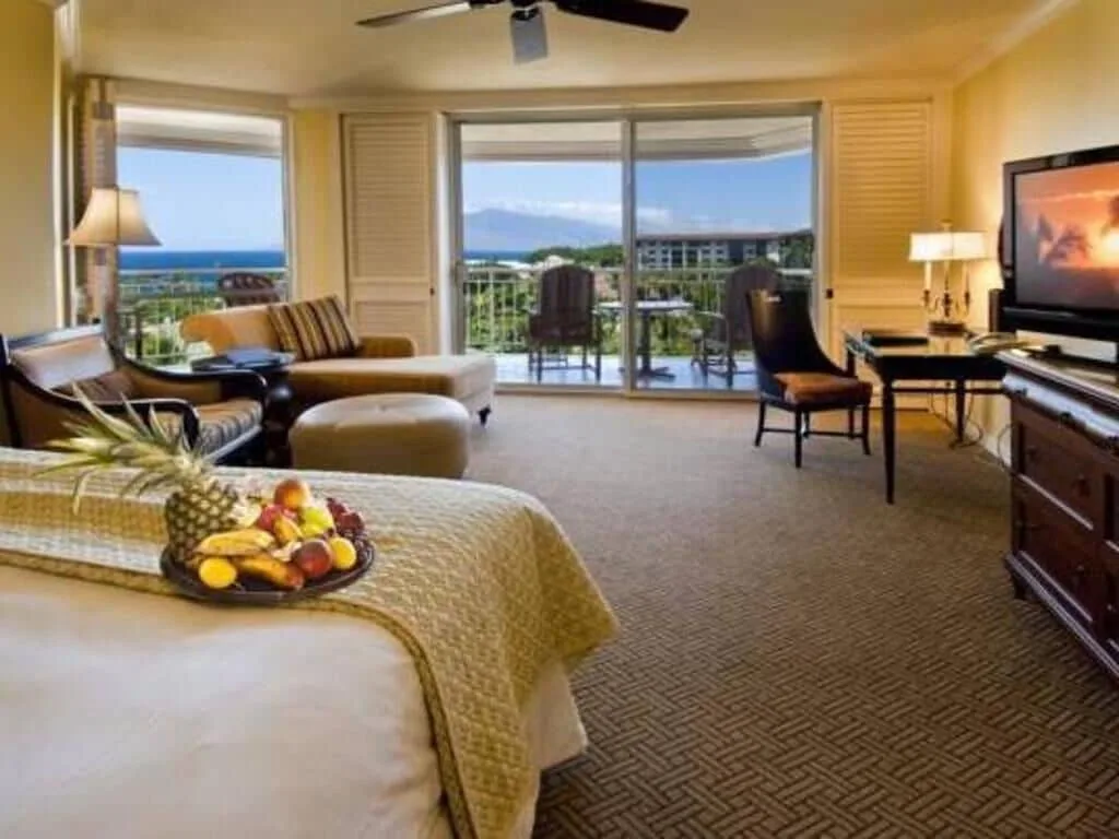 Deluxe Room Ocean View with bed, seating area, balcony and ocean at Grand Wailea Maui.