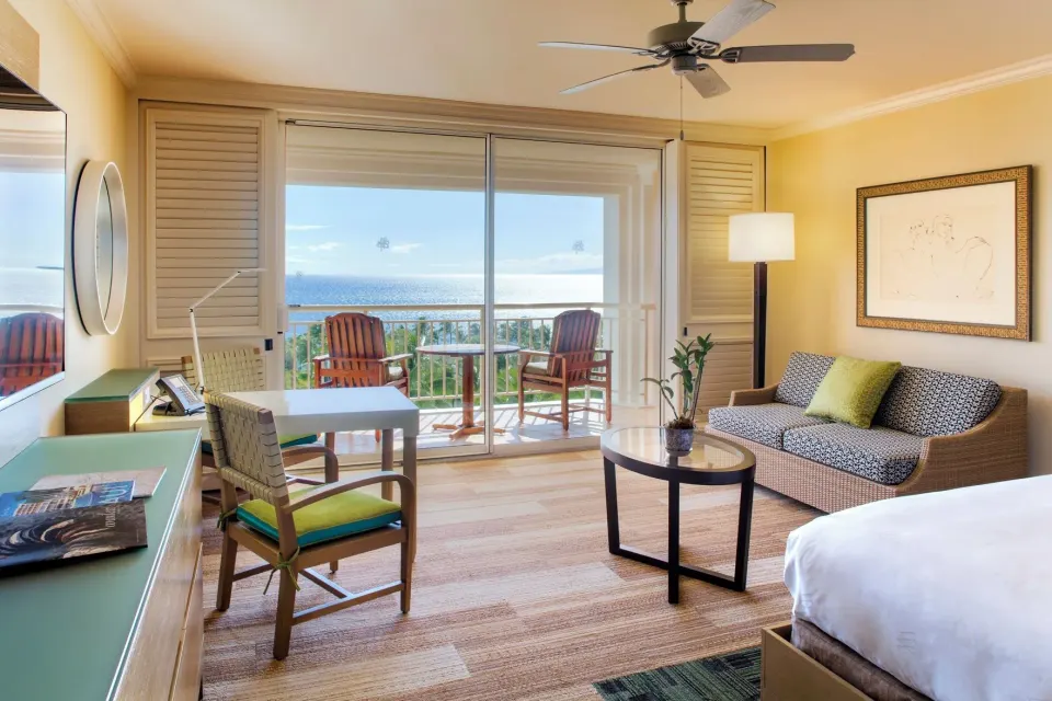 Deluxe Room Ocean View with king bed, desk, sofa and balcony at Grand Wailea Maui.