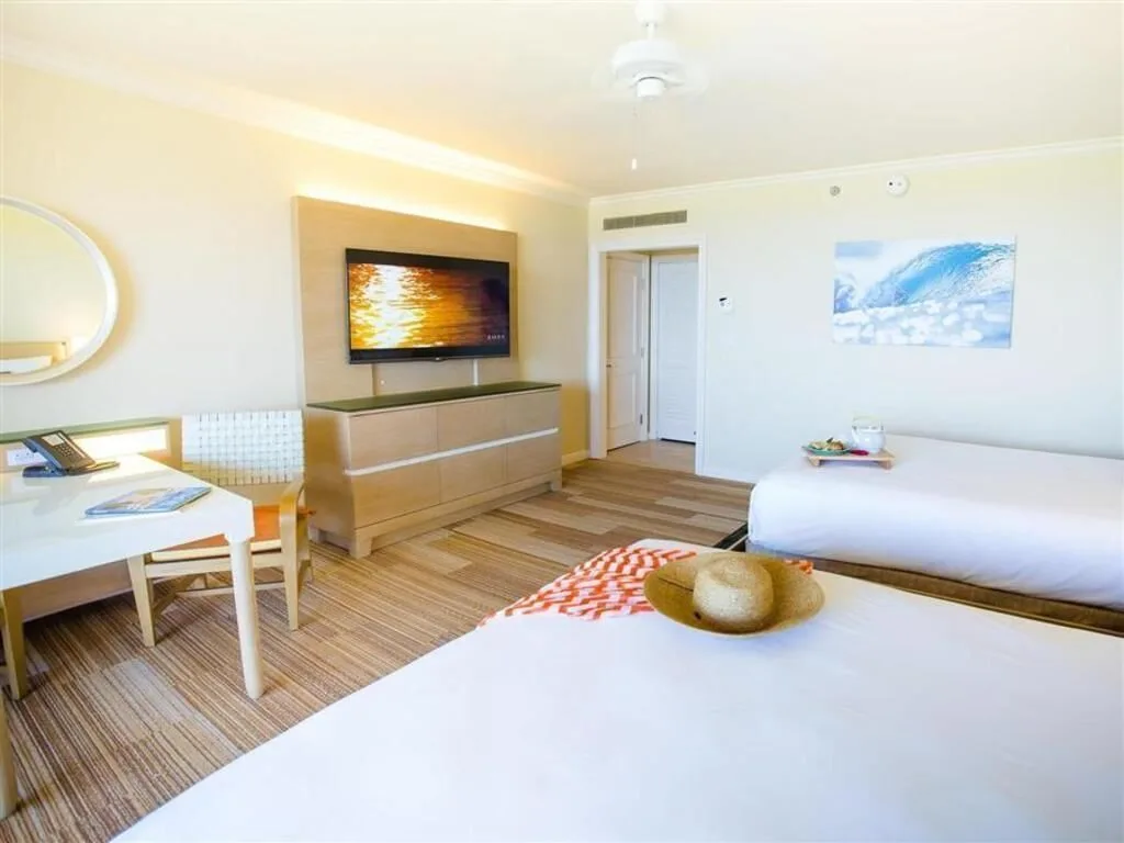 Deluxe Room Ocean View with two beds, TV, and desk at Grand Wailea Maui.