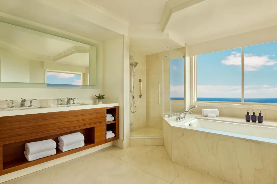 Ocean-view bathroom in a Deluxe Suite at Grand Wailea Maui with soaking tub, shower and double vanity.