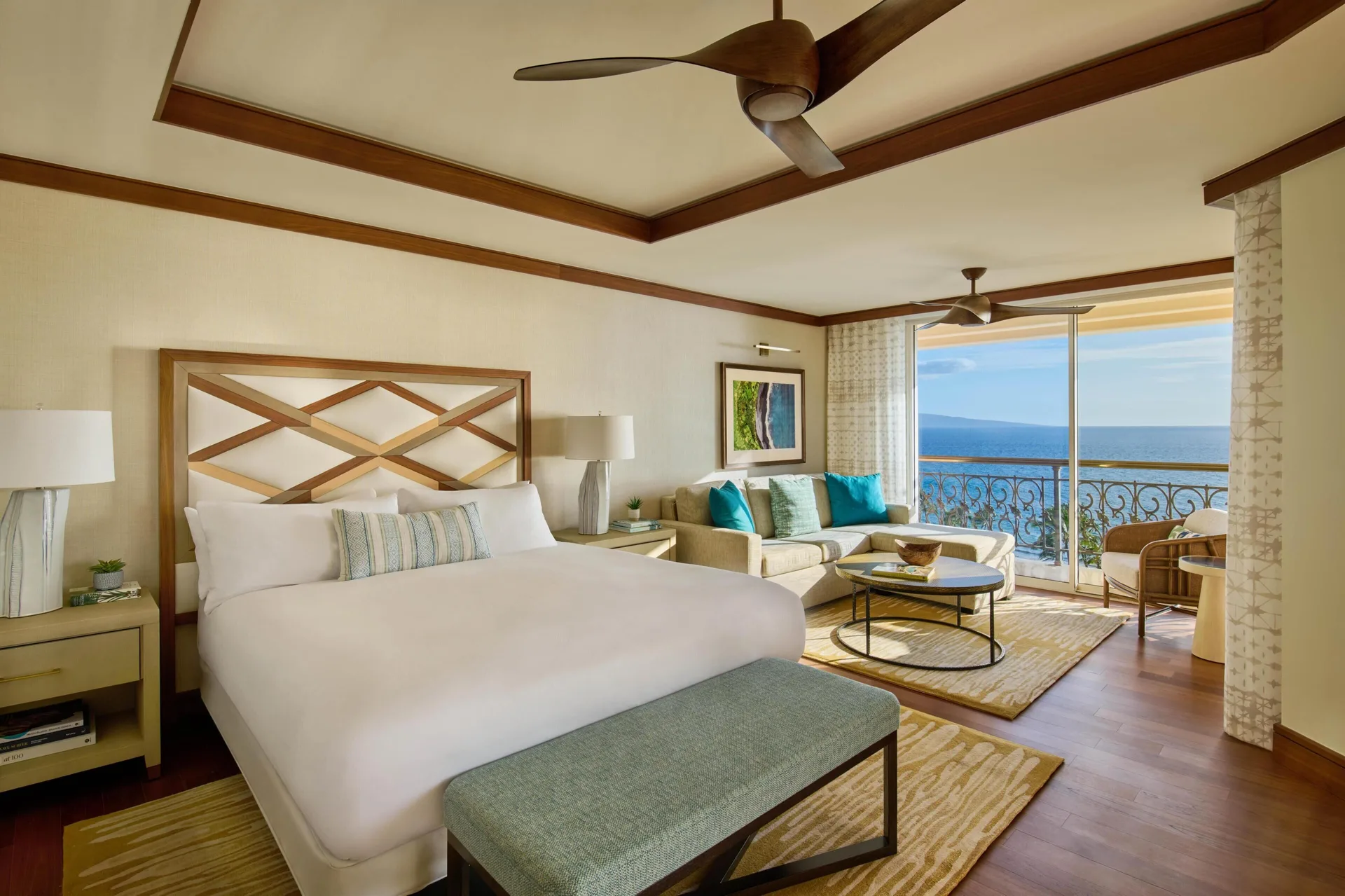 King bedroom with sofa seating and ocean-facing balcony at Grand Wailea Maui.