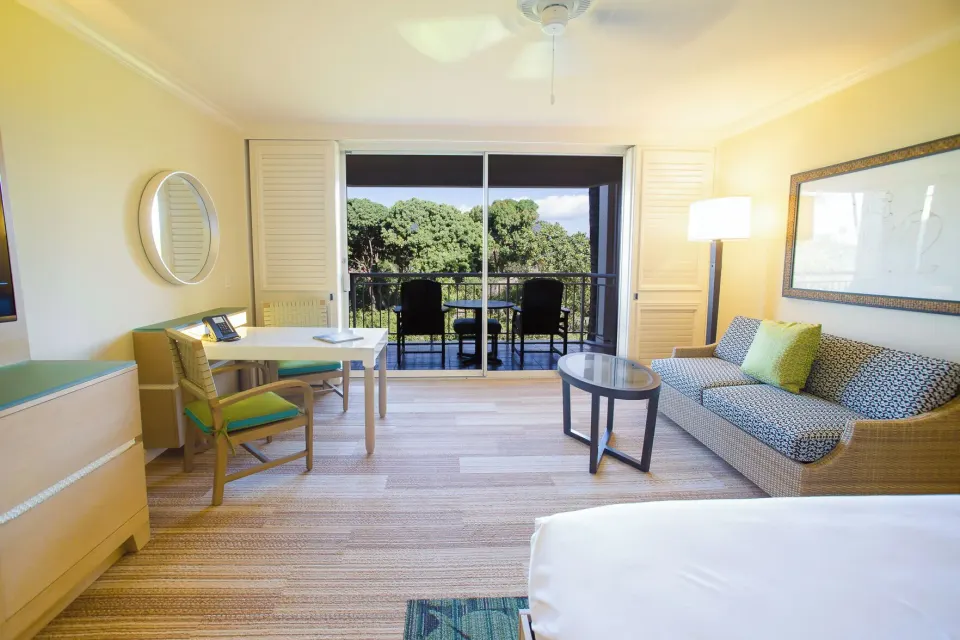 Accessible garden view room seating area with sofa and lanai at Grand Wailea Maui.