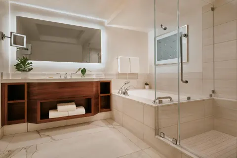 Spacious bathroom with tub, glass shower, and vanity at Grand Wailea Maui.