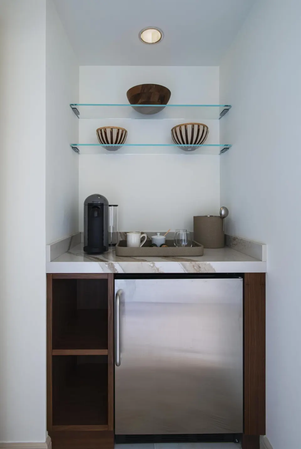 In-room refreshment nook with mini fridge and coffee setup at Grand Wailea Maui.