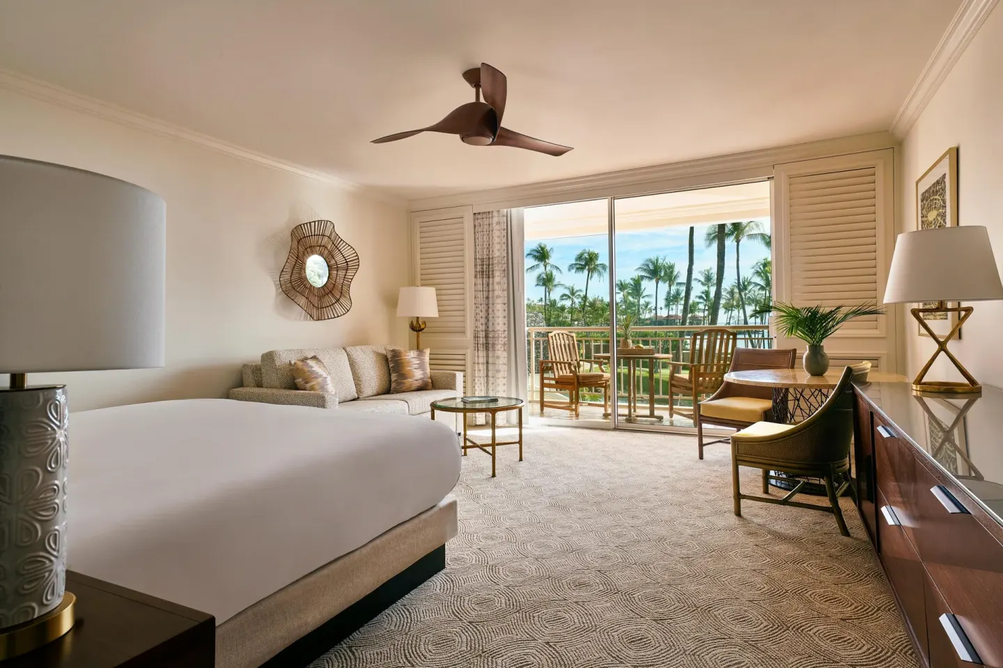 Ocean-view sofa bed room with bed, seating area, desk, and lanai at Grand Wailea Maui.