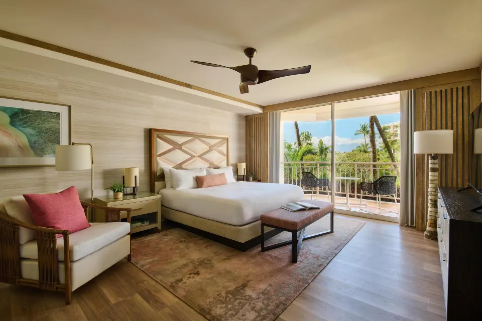 Garden view one-bedroom suite with king bed and balcony at Grand Wailea Maui.