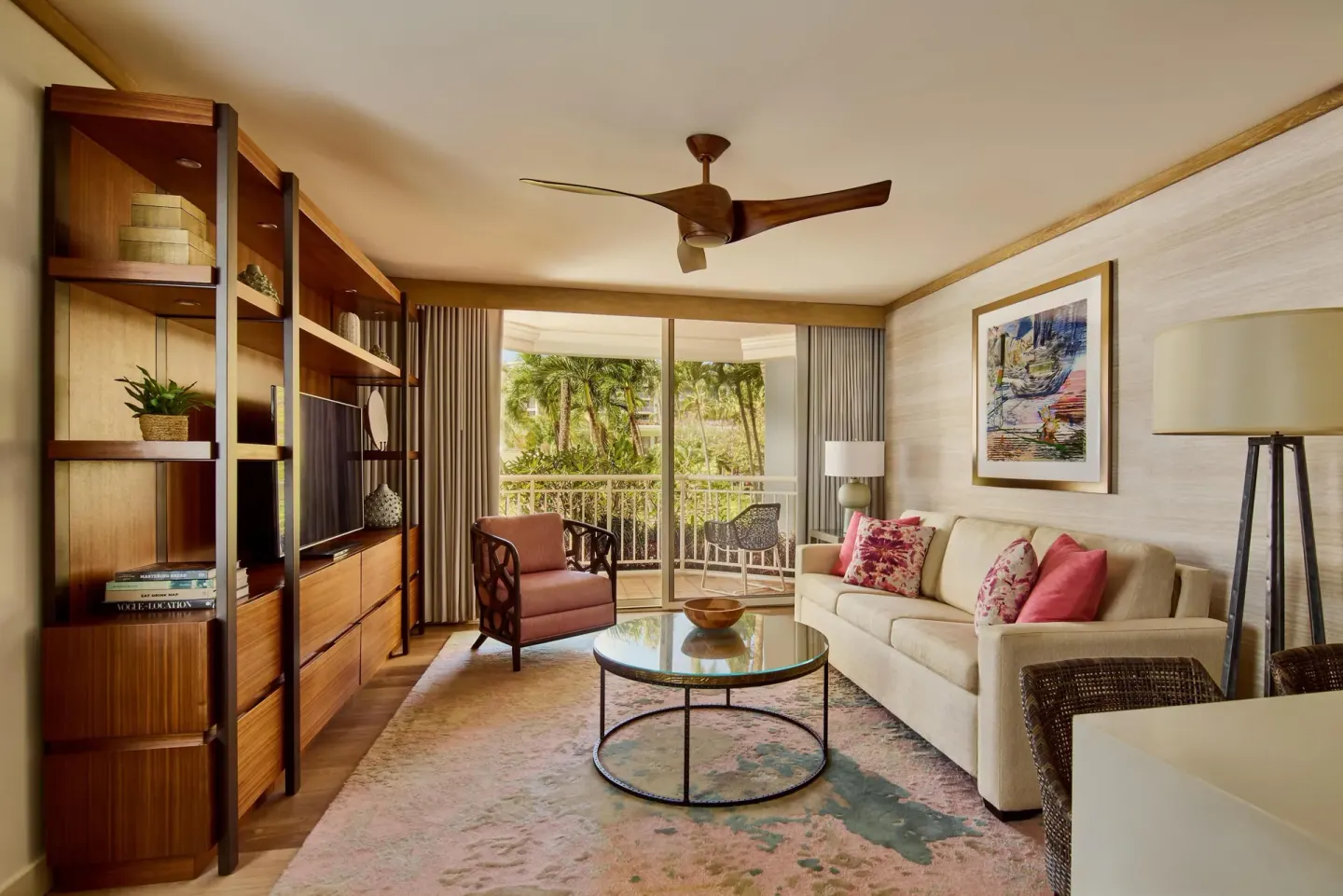Garden view suite living room with sofa and lanai doors at Grand Wailea Maui.