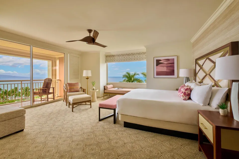 Ocean view one-bedroom suite with king bed and balcony at Grand Wailea Maui.