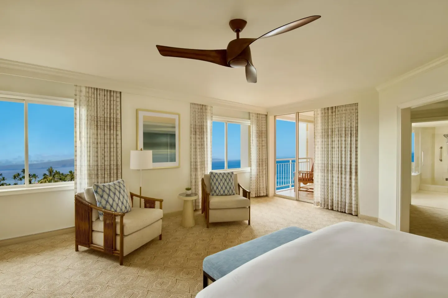 Ocean-view bedroom with king bed, chairs and balcony at Grand Wailea Maui.