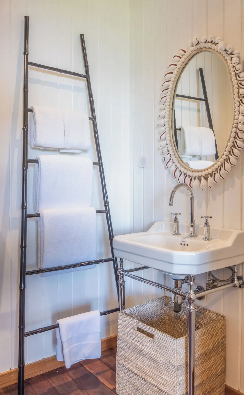 Bathroom sink, shell-framed mirror, and towel ladder at GYP SEA Saint Barth.