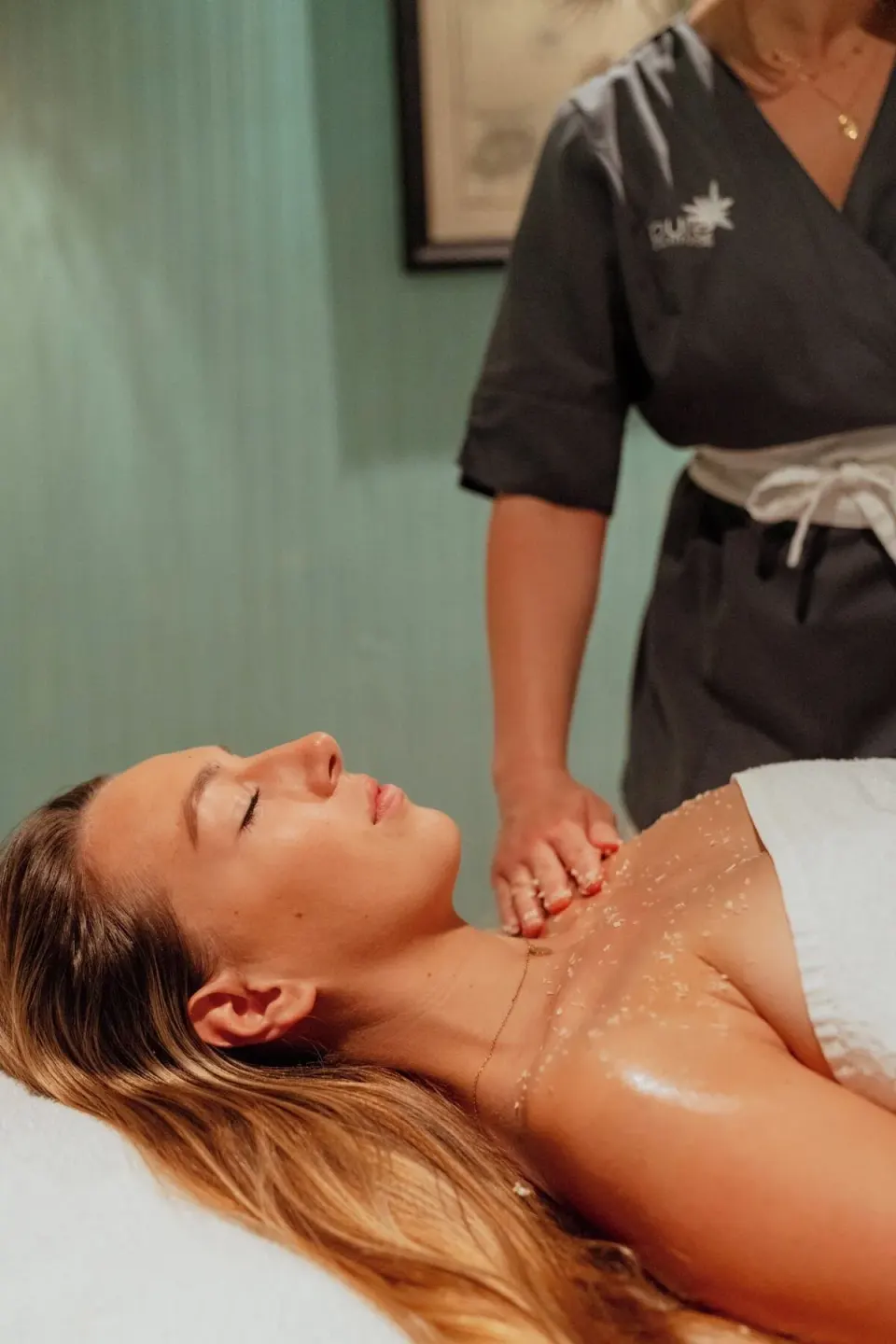 Therapist giving a shoulder treatment to a guest at the spa at GYP SEA Saint Barth.