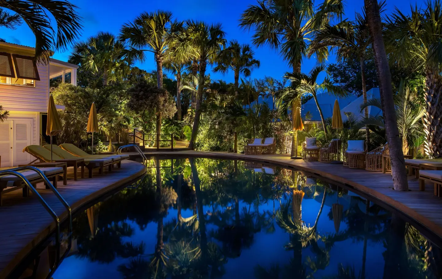 Illuminated swimming pool and palms at dusk at GYP SEA Saint Barth.