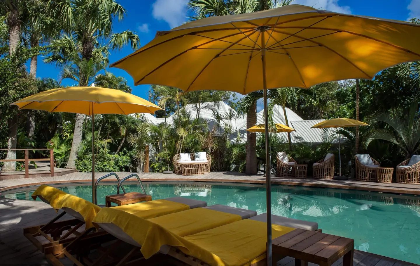 Yellow loungers and umbrellas beside the swimming pool at GYP SEA Saint Barth.