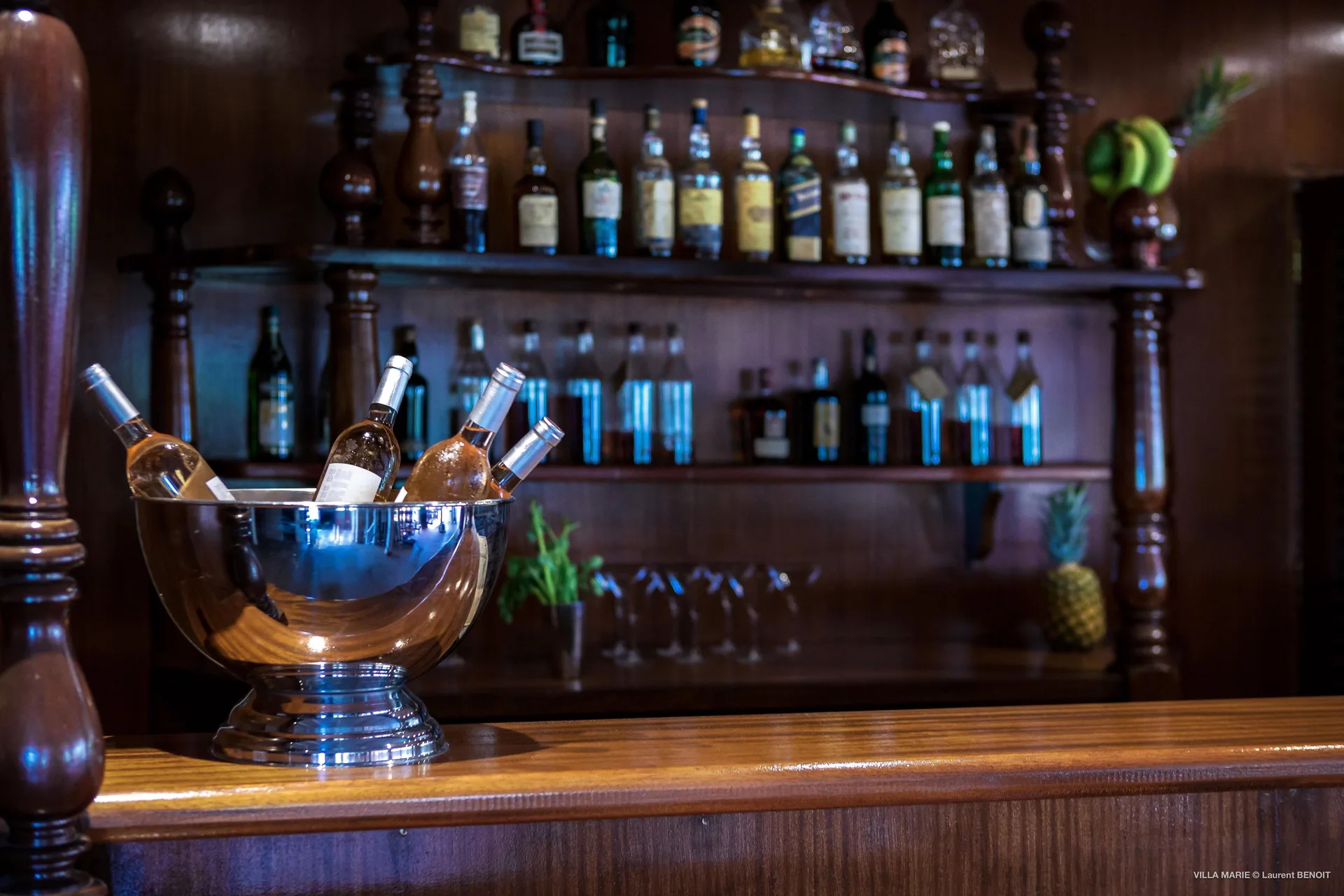 Wooden bar with chilled wine bottles at GYP SEA Saint Barth.