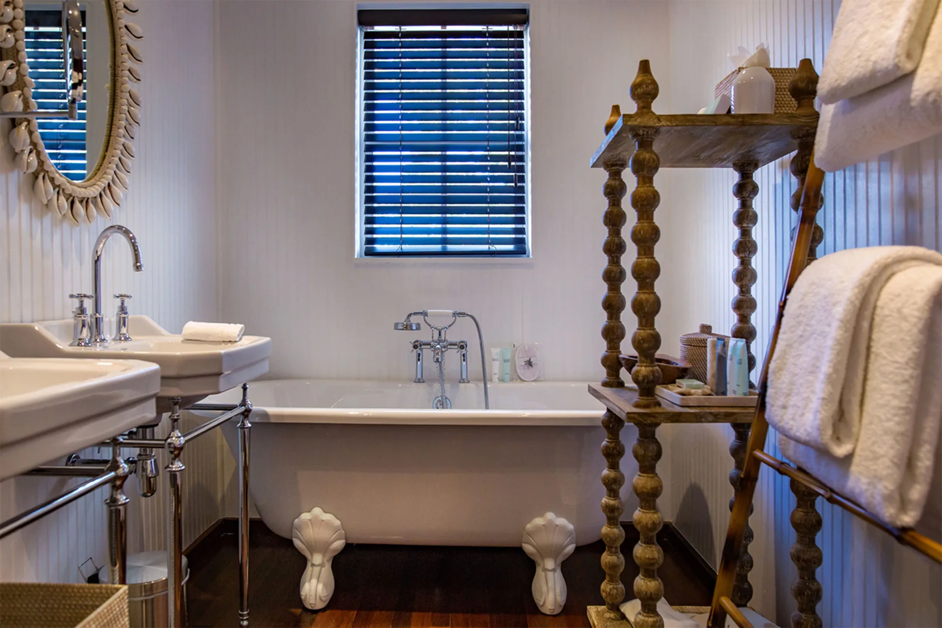 Bungalow Caribbean bathroom with clawfoot tub and twin sinks at GYP SEA Saint Barth.