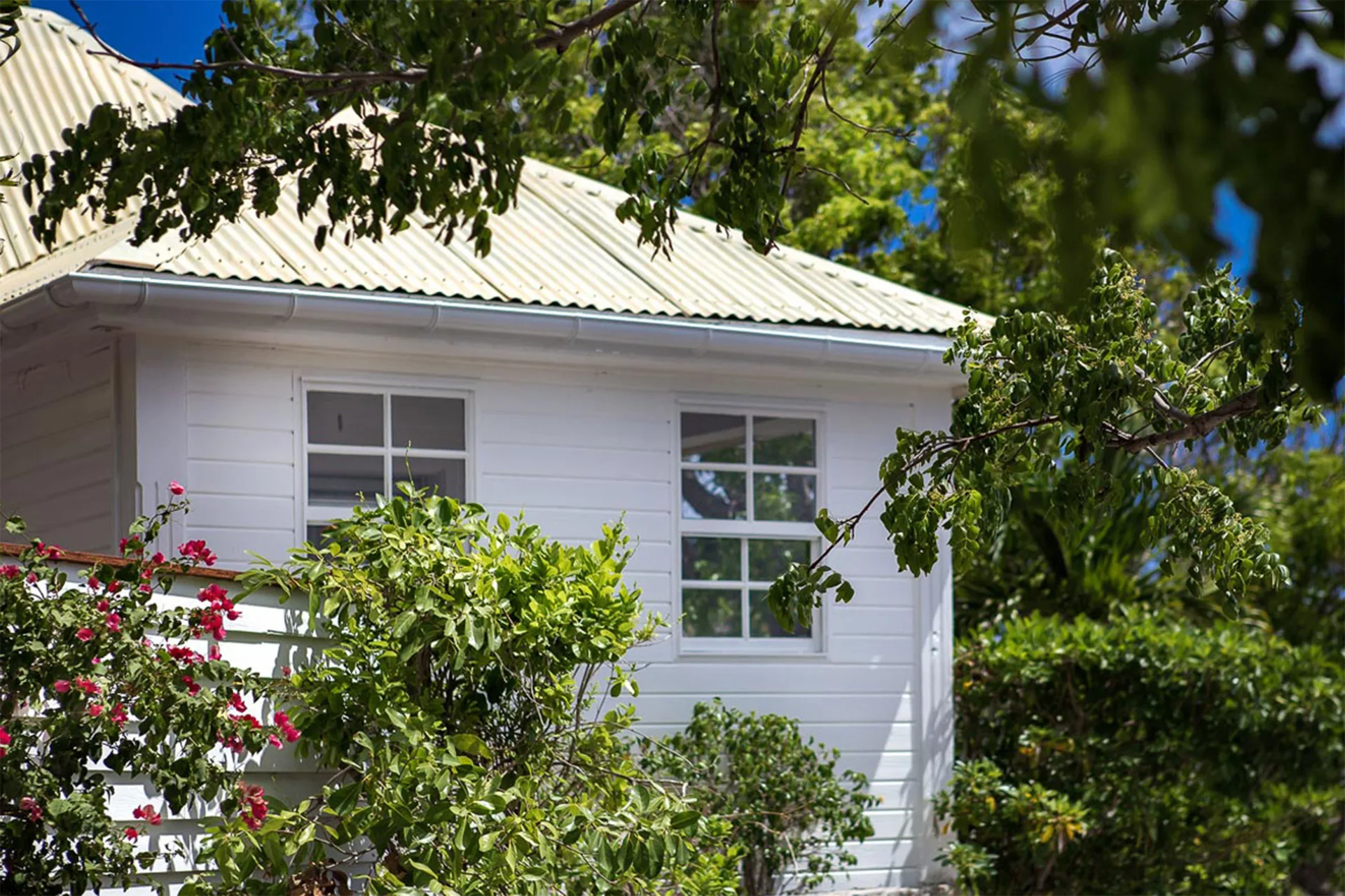White Bungalow Caribbean exterior among tropical greenery at GYP SEA Saint Barth.