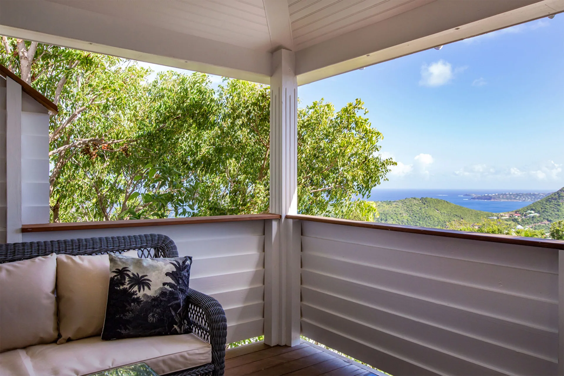 Bungalow Caribbean veranda with cushioned seating and sea view at GYP SEA Saint Barth.