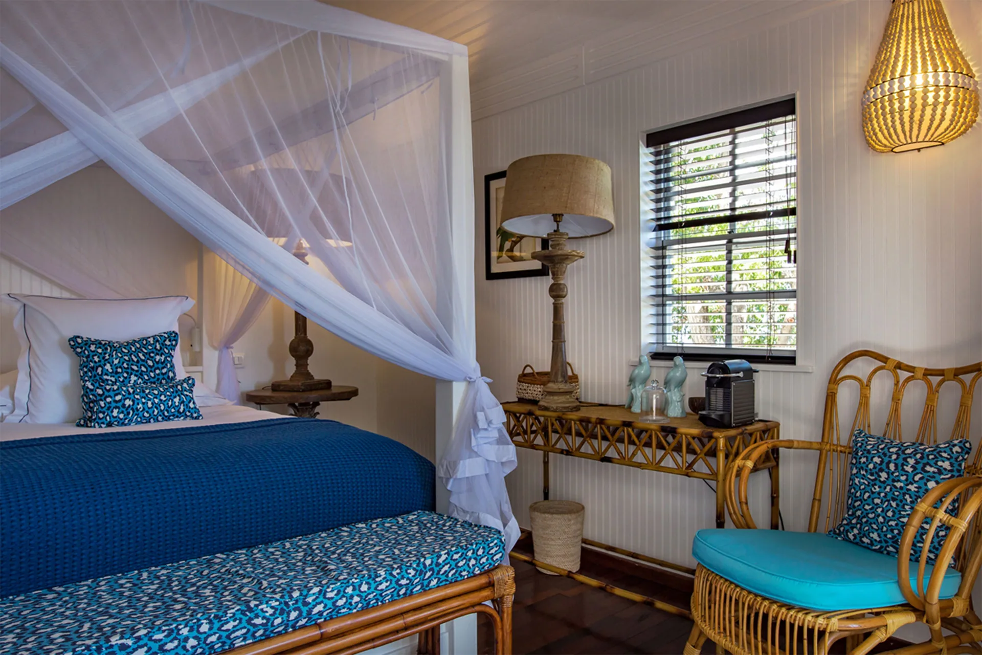Caribbean Bungalow bed and rattan sitting corner at GYP SEA Saint Barth.