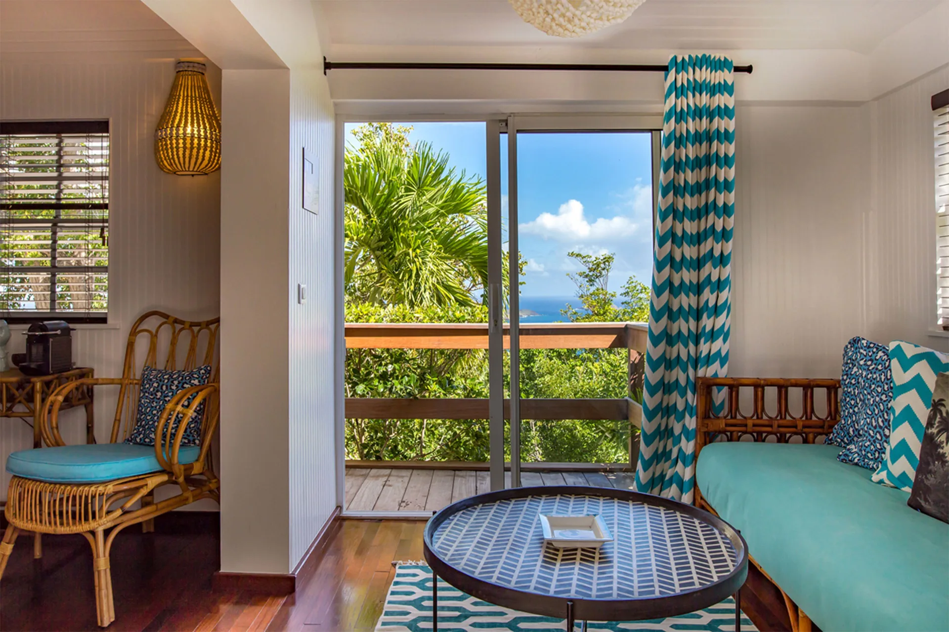 Caribbean Bungalow lounge with balcony and ocean view at GYP SEA Saint Barth.