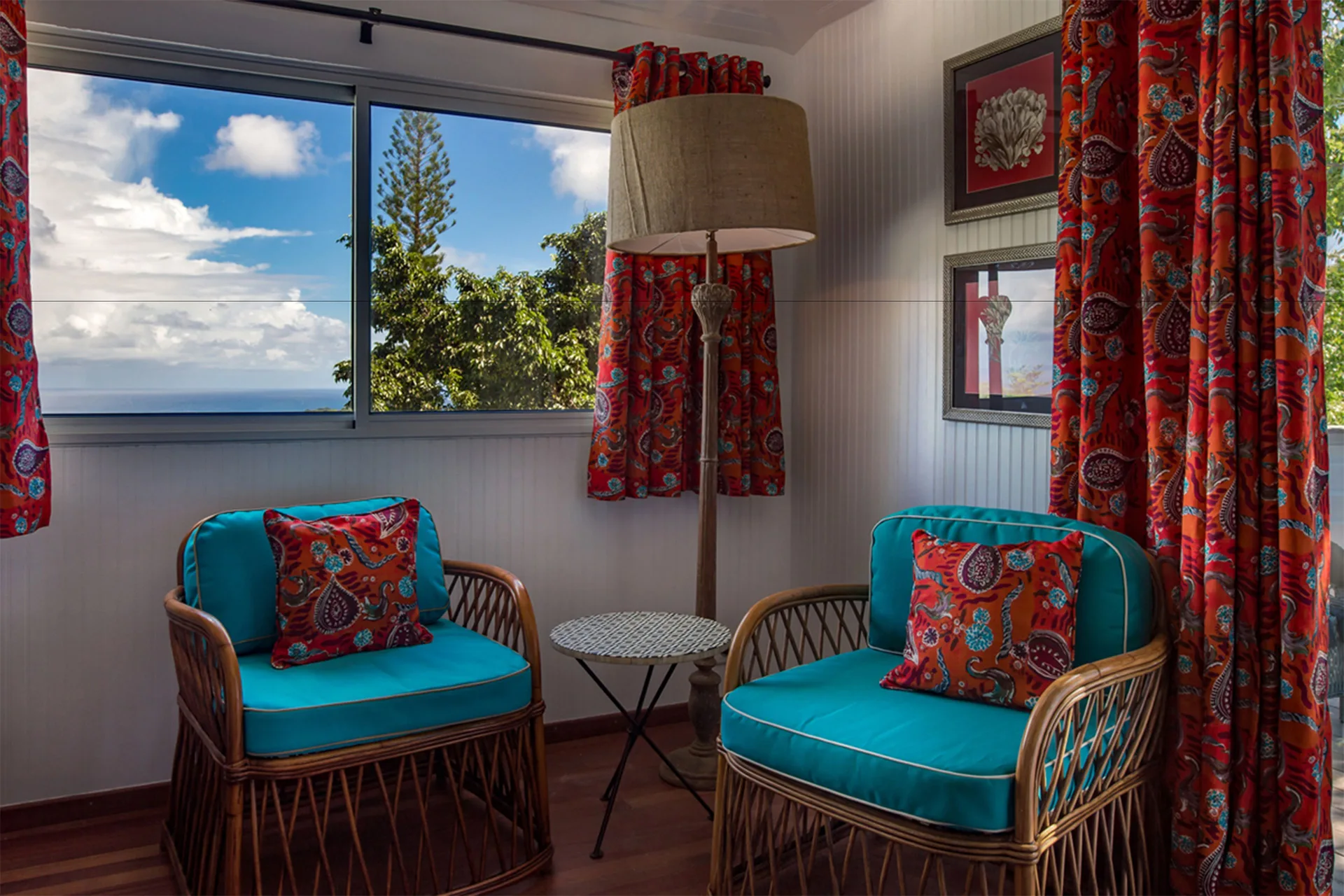 Caribbean Bungalow rattan chairs by a window with sea view at GYP SEA Saint Barth.