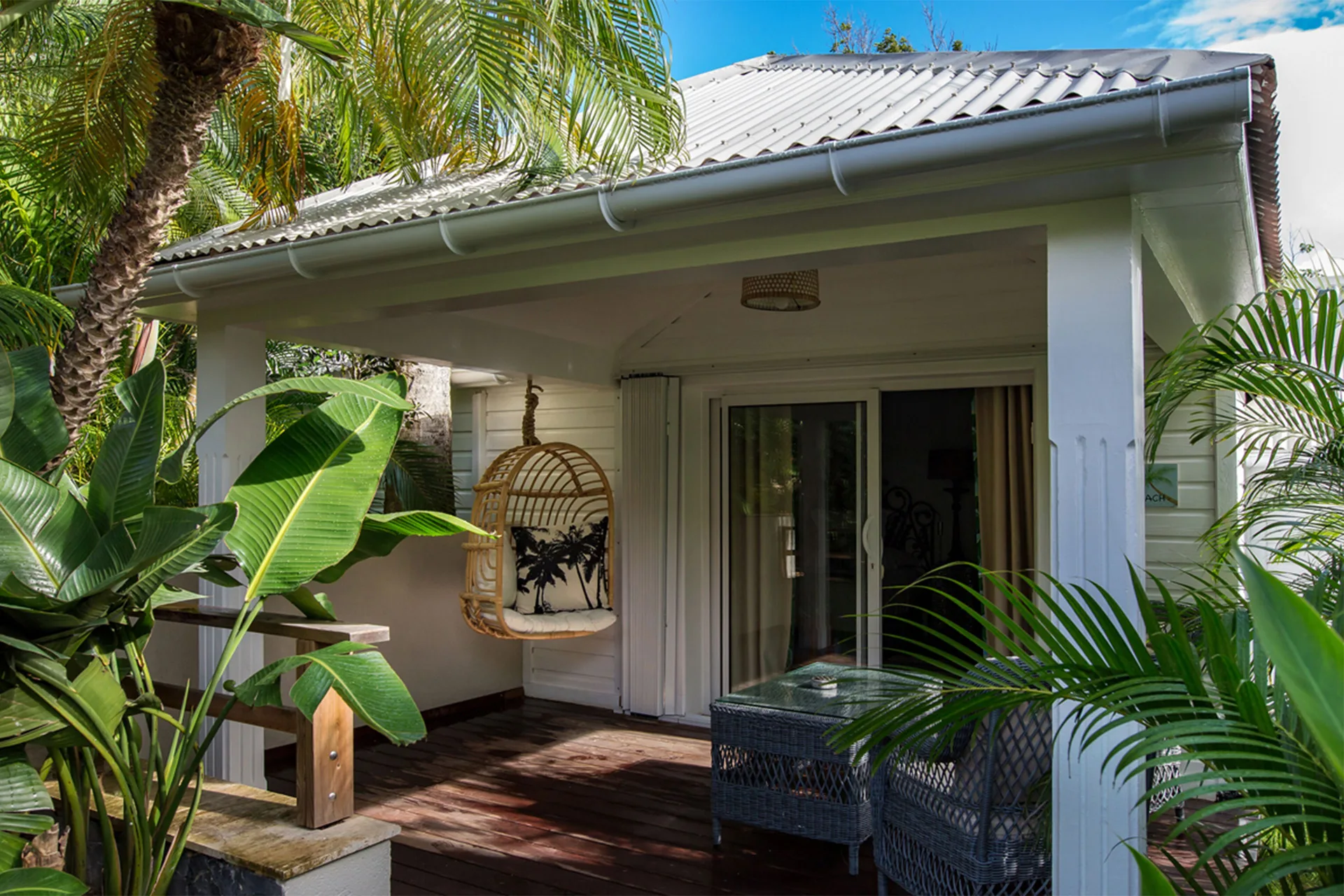 Bungalow Plantation terrace with hanging chair and tropical plants at GYP SEA Saint Barth.