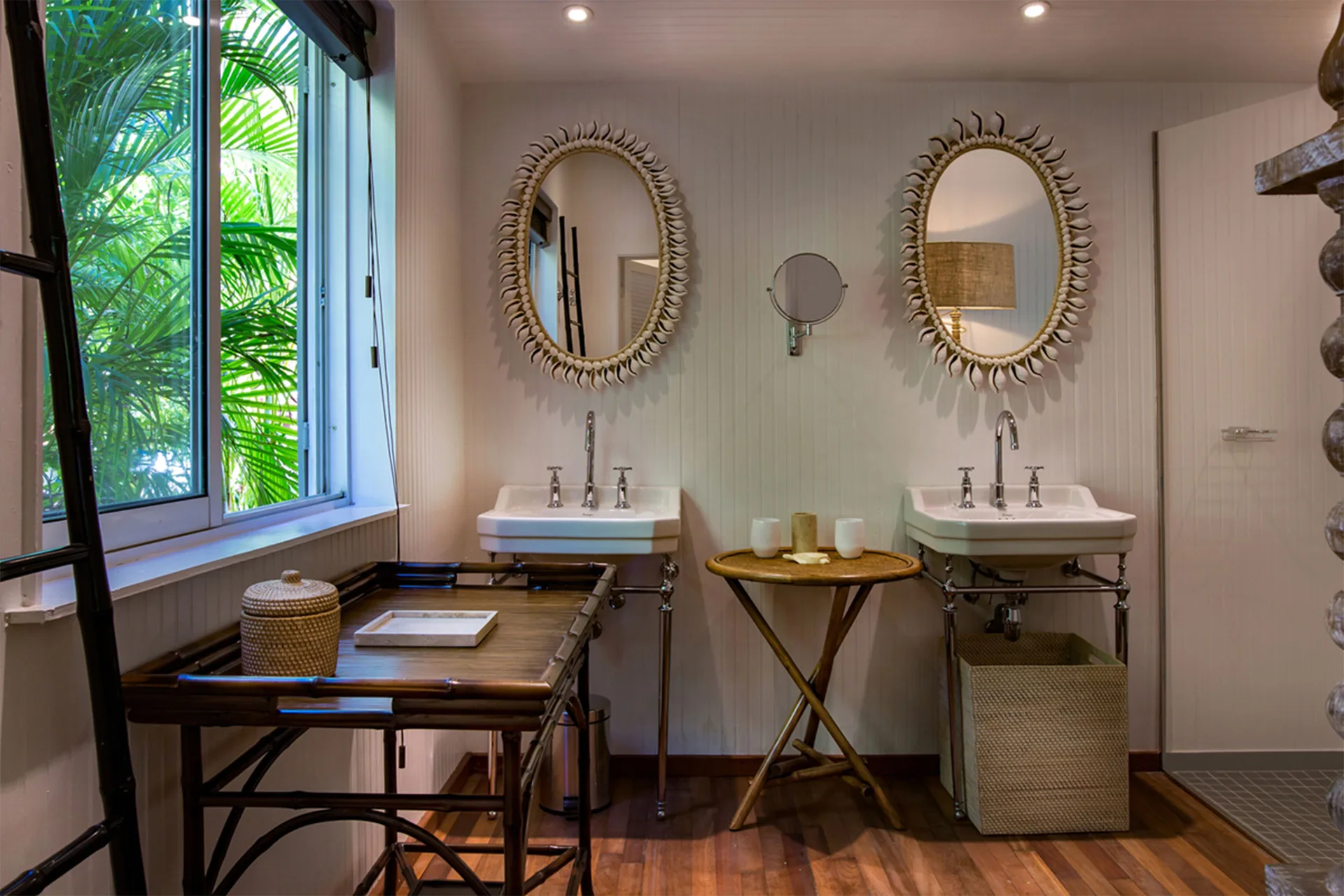 Bungalow Plantation bathroom with twin sinks and round mirrors at GYP SEA Saint Barth.