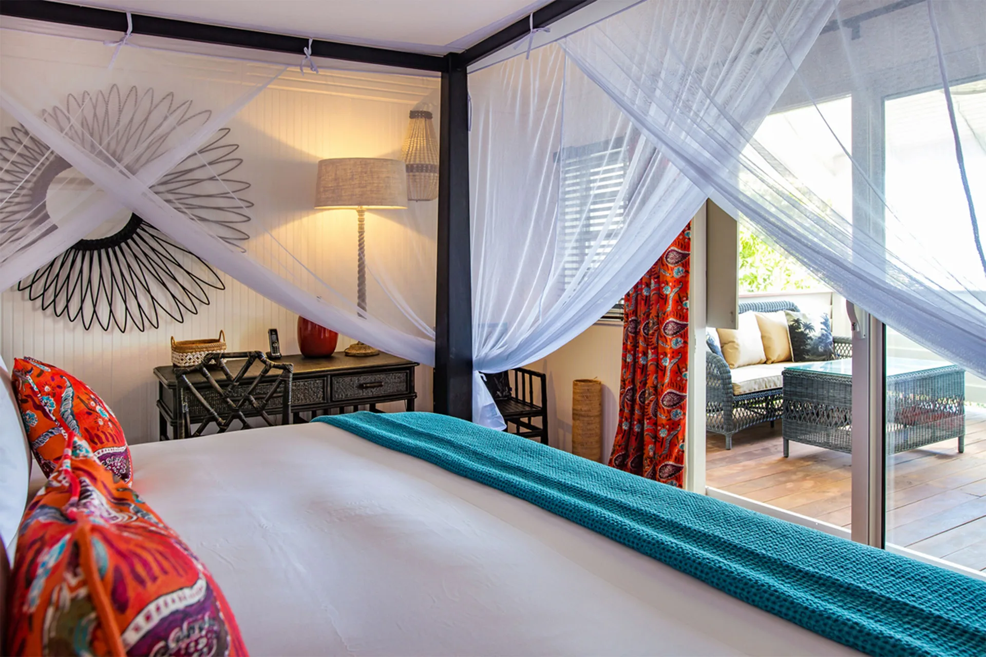 Prestige Caribbean bungalow bed beside sliding doors to terrace at GYP SEA Saint Barth.