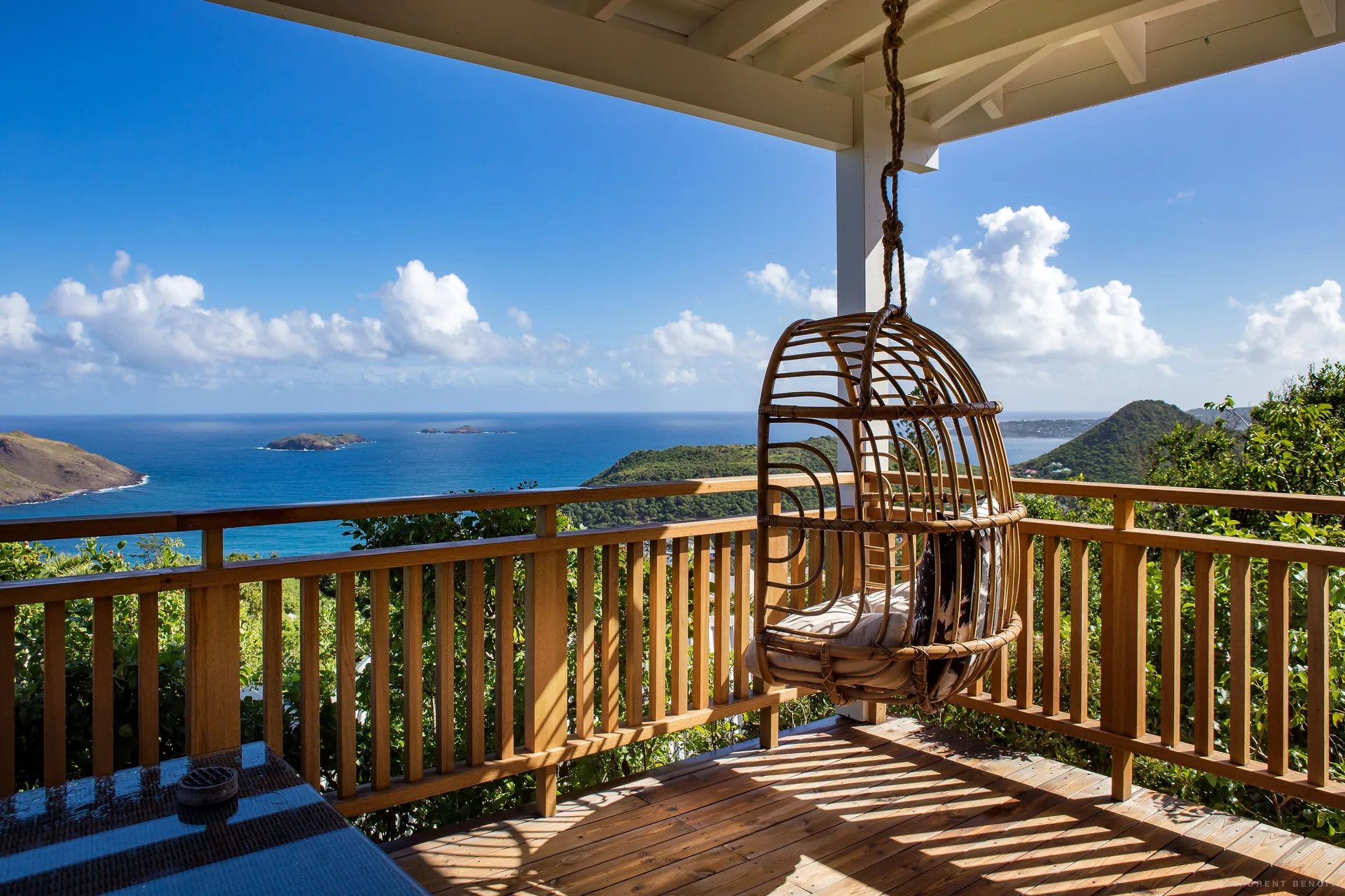 Bungalow terrace with hanging chair and ocean view at GYP SEA Saint Barth.