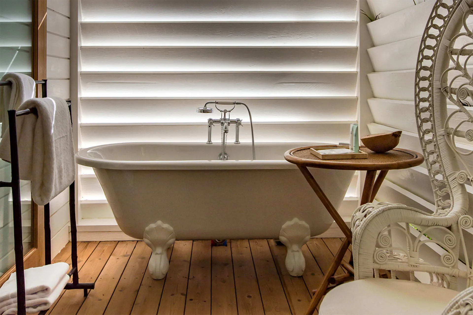 Tropical Bungalow bathroom with clawfoot tub and white shutters at GYP SEA Saint Barth.