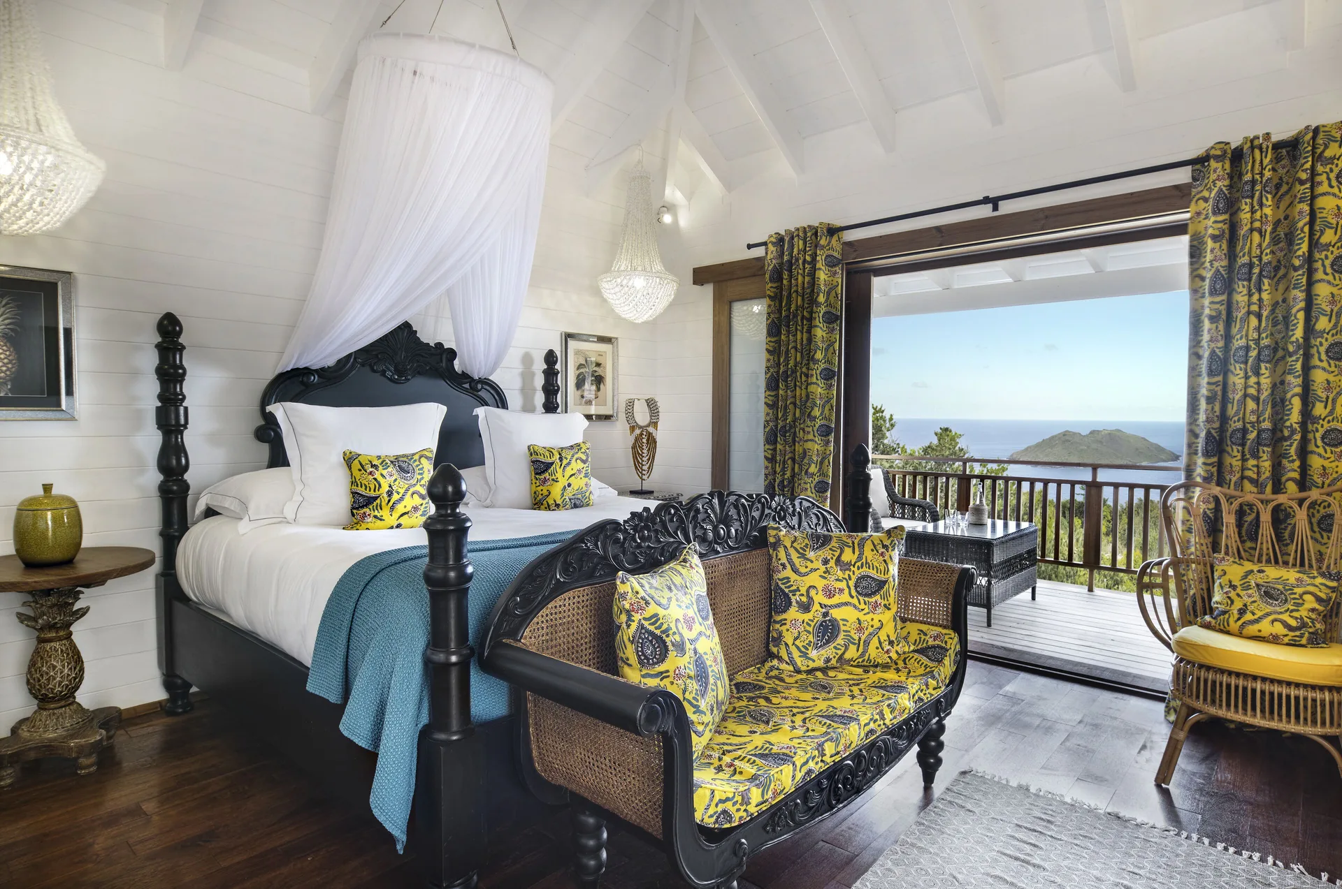 Tropical Bungalow king bed with canopy and balcony view at GYP SEA Saint Barth.