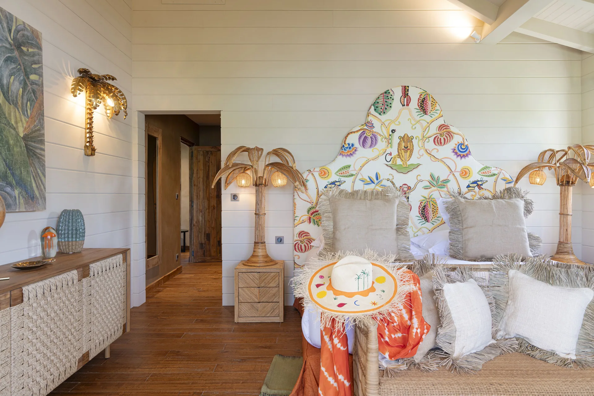 Bedroom with patterned headboard and rattan lamps at GYP SEA Saint Barth.