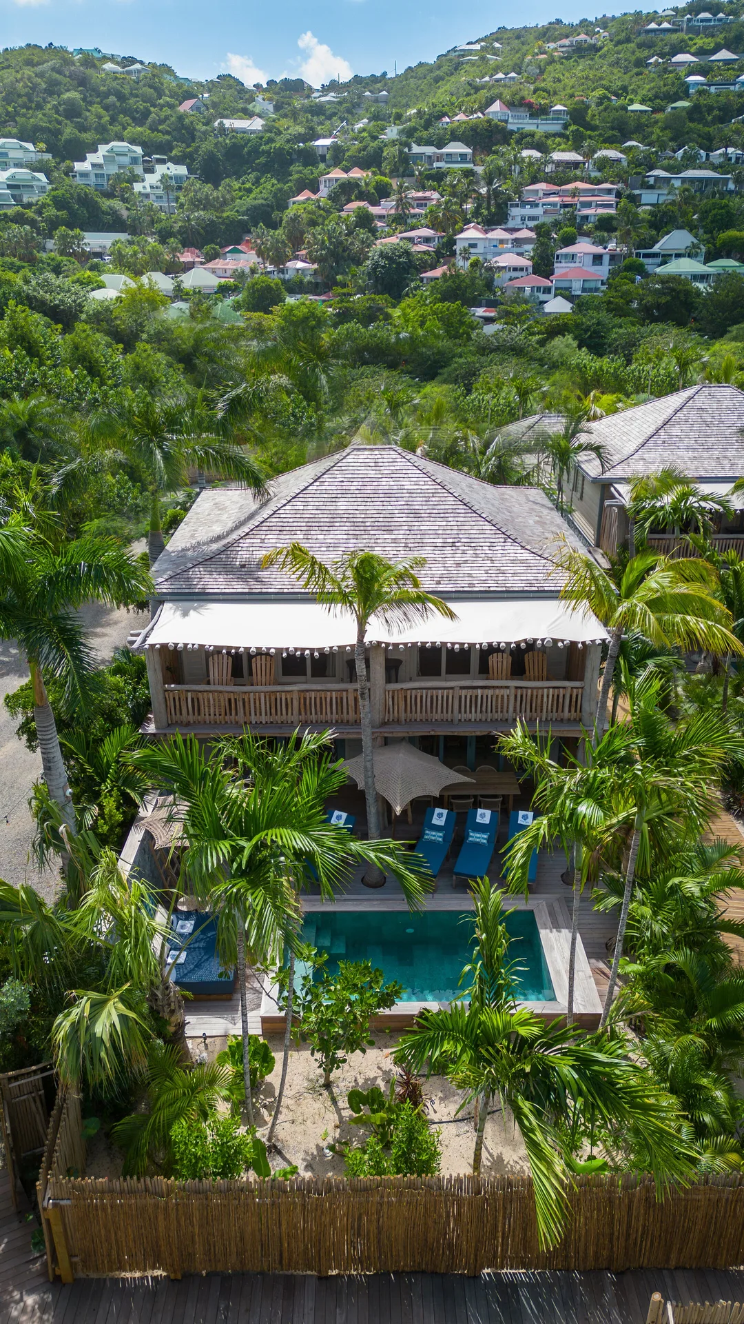 Aerial view of Coco Mango Beach House with pool and palms at GYP SEA Saint Barth.
