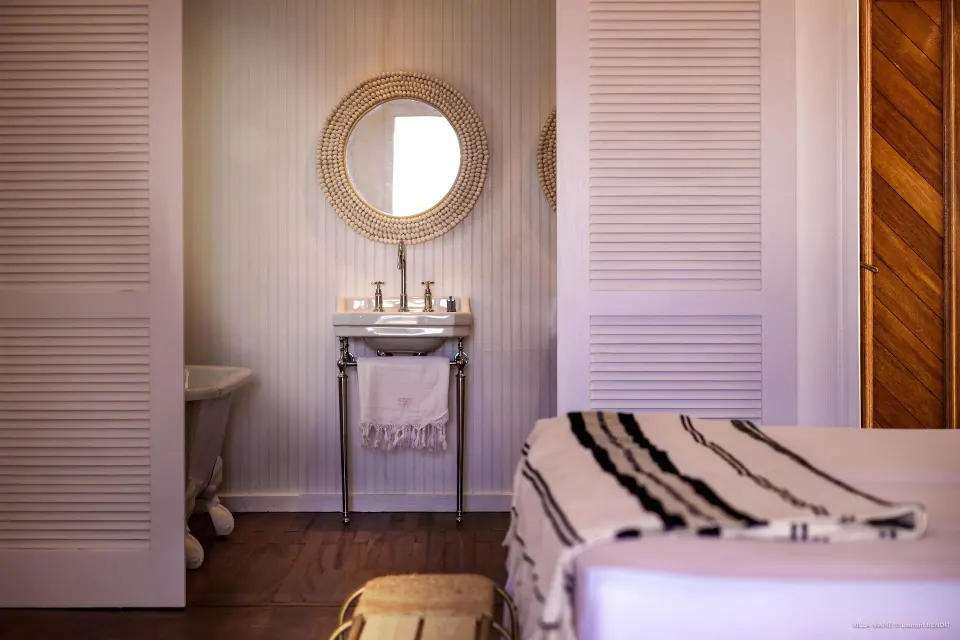 Family Suite bathroom vanity and bed at GYP SEA Saint Barth.