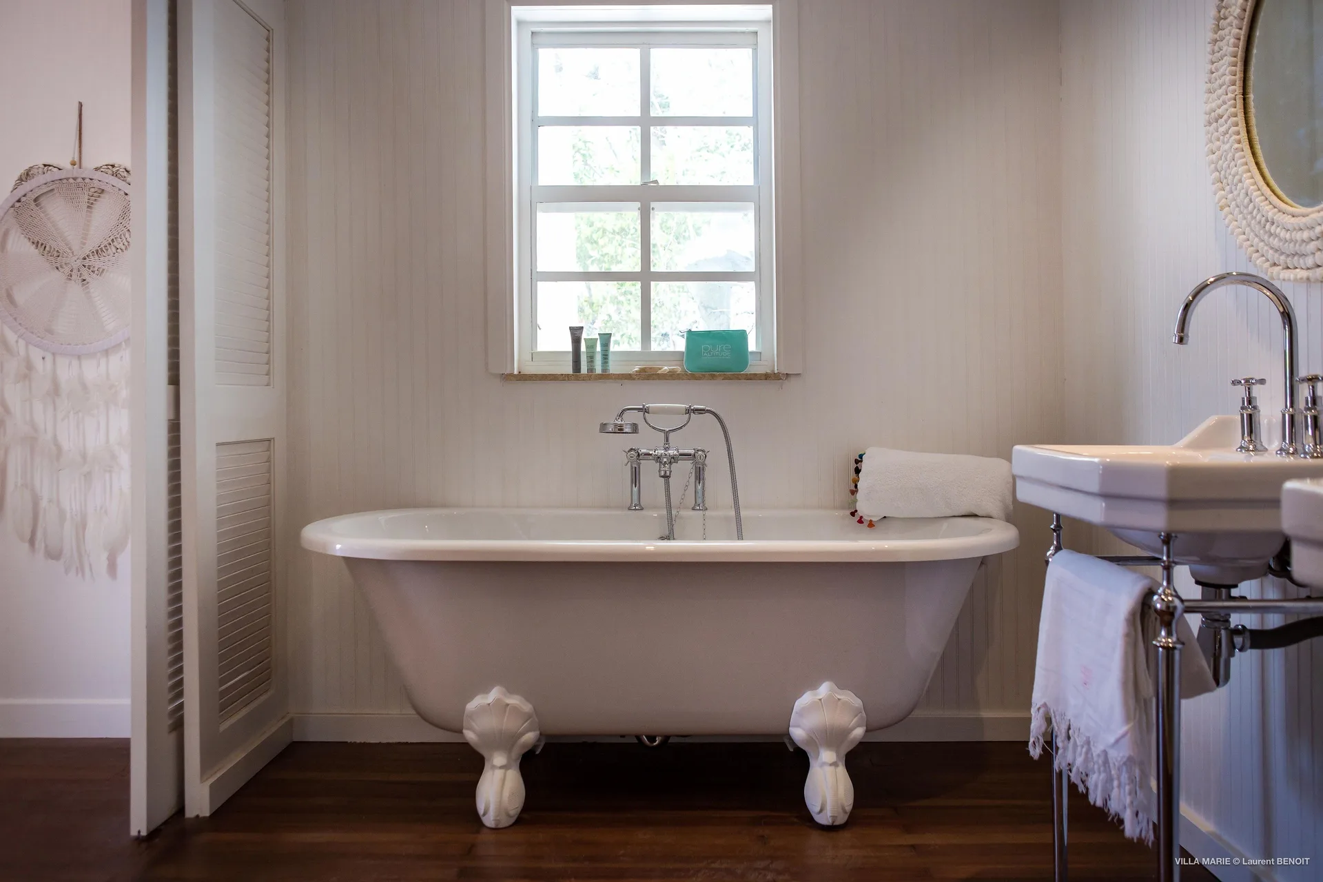 Family Suite clawfoot bathtub beside a window at GYP SEA Saint Barth.