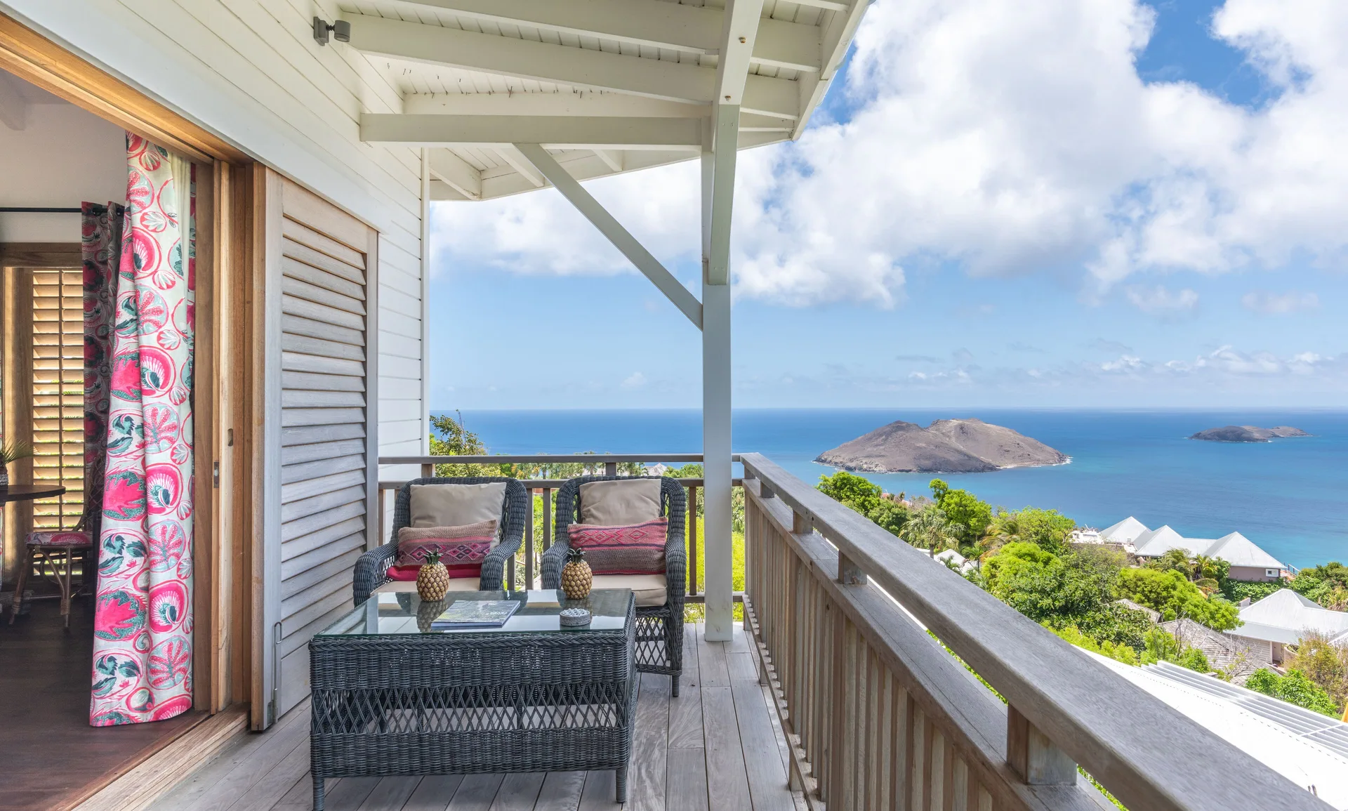 Havana Suite balcony seating with sea and island views at GYP SEA Saint Barth.